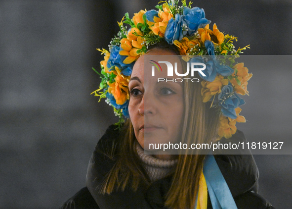 KRAKOW, POLAND - NOVEMBER 28:
A protester wearing a wreath in Ukrainian colors on the evening of the 1009th day of Russia's invasion of Ukra...