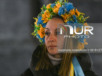 KRAKOW, POLAND - NOVEMBER 28:
A protester wearing a wreath in Ukrainian colors on the evening of the 1009th day of Russia's invasion of Ukra...