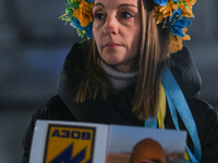 KRAKOW, POLAND - NOVEMBER 28:
A protester wearing a wreath in Ukrainian colors on the evening of the 1009th day of Russia's invasion of Ukra...