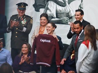 Mexico's President Claudia Sheinbaum Pardo holds a sweatshirt during the National Sports Award 2024 at the National Palace in Mexico City, M...