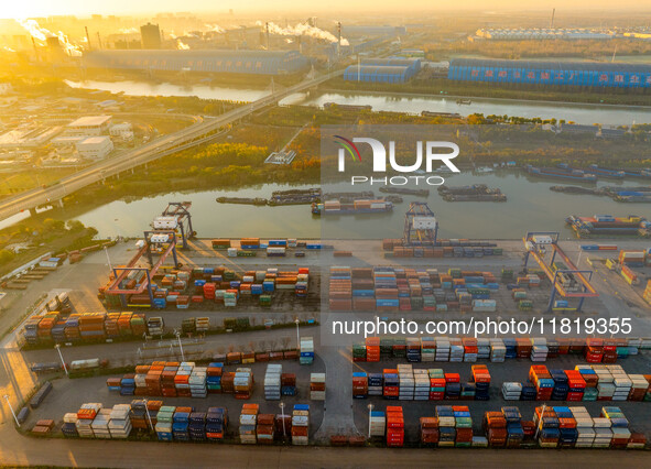 Containers wait to be loaded and unloaded at the terminal of Huaian Port Logistics Group in Huai'an, Jiangsu province, China, on November 29...