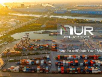 Containers wait to be loaded and unloaded at the terminal of Huaian Port Logistics Group in Huai'an, Jiangsu province, China, on November 29...