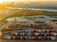 Containers wait to be loaded and unloaded at the terminal of Huaian Port Logistics Group in Huai'an, Jiangsu province, China, on November 29...