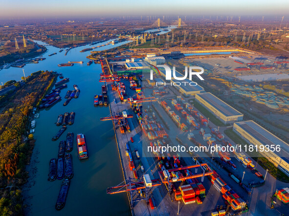 Containers wait to be loaded and unloaded at the terminal of Huaian Port Logistics Group in Huai'an, Jiangsu province, China, on November 29...