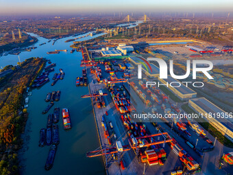 Containers wait to be loaded and unloaded at the terminal of Huaian Port Logistics Group in Huai'an, Jiangsu province, China, on November 29...