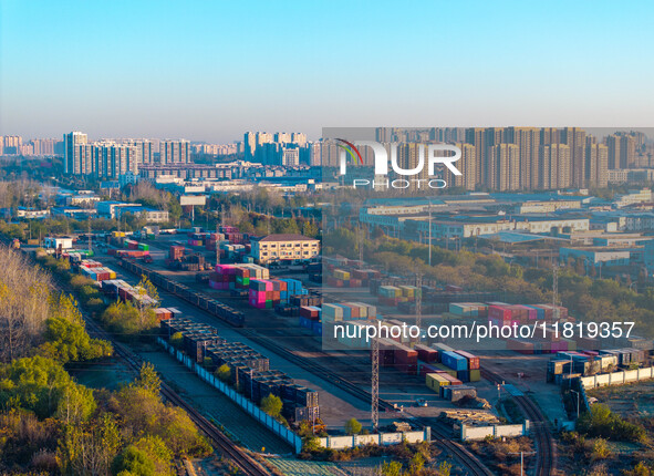 Containers wait to be loaded and unloaded at the terminal of Huaian Port Logistics Group in Huai'an, Jiangsu province, China, on November 29...