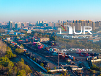 Containers wait to be loaded and unloaded at the terminal of Huaian Port Logistics Group in Huai'an, Jiangsu province, China, on November 29...