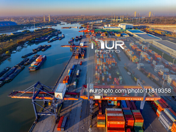 Containers wait to be loaded and unloaded at the terminal of Huaian Port Logistics Group in Huai'an, Jiangsu province, China, on November 29...