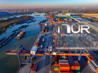 Containers wait to be loaded and unloaded at the terminal of Huaian Port Logistics Group in Huai'an, Jiangsu province, China, on November 29...