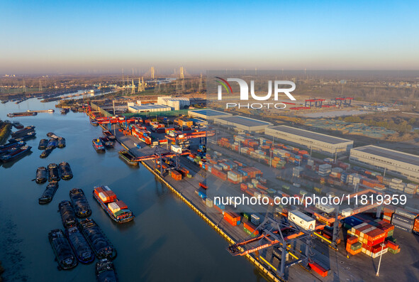 Containers wait to be loaded and unloaded at the terminal of Huaian Port Logistics Group in Huai'an, Jiangsu province, China, on November 29...