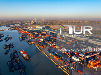 Containers wait to be loaded and unloaded at the terminal of Huaian Port Logistics Group in Huai'an, Jiangsu province, China, on November 29...