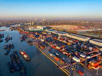 Containers wait to be loaded and unloaded at the terminal of Huaian Port Logistics Group in Huai'an, Jiangsu province, China, on November 29...