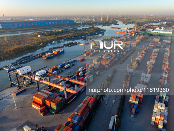 Containers wait to be loaded and unloaded at the terminal of Huaian Port Logistics Group in Huai'an, Jiangsu province, China, on November 29...