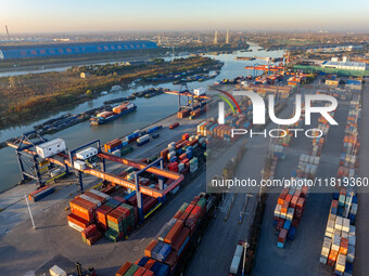 Containers wait to be loaded and unloaded at the terminal of Huaian Port Logistics Group in Huai'an, Jiangsu province, China, on November 29...