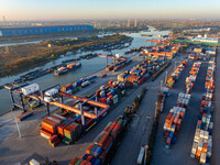 Containers wait to be loaded and unloaded at the terminal of Huaian Port Logistics Group in Huai'an, Jiangsu province, China, on November 29...