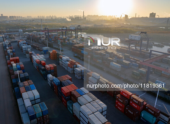 Containers wait to be loaded and unloaded at the terminal of Huaian Port Logistics Group in Huai'an, Jiangsu province, China, on November 29...