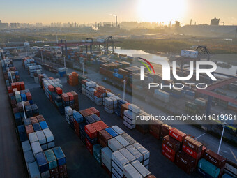 Containers wait to be loaded and unloaded at the terminal of Huaian Port Logistics Group in Huai'an, Jiangsu province, China, on November 29...