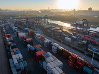 Containers wait to be loaded and unloaded at the terminal of Huaian Port Logistics Group in Huai'an, Jiangsu province, China, on November 29...