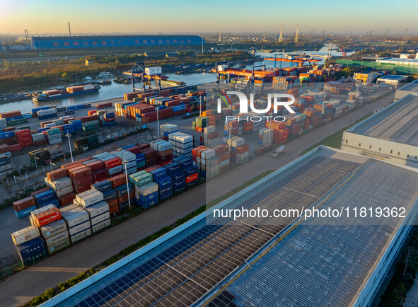 Containers wait to be loaded and unloaded at the terminal of Huaian Port Logistics Group in Huai'an, Jiangsu province, China, on November 29...