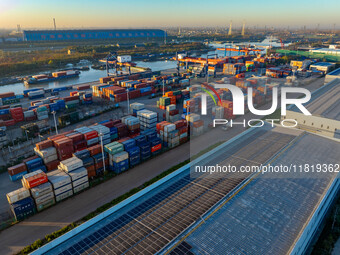 Containers wait to be loaded and unloaded at the terminal of Huaian Port Logistics Group in Huai'an, Jiangsu province, China, on November 29...