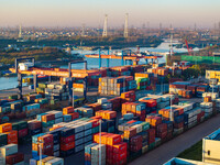 Containers wait to be loaded and unloaded at the terminal of Huaian Port Logistics Group in Huai'an, Jiangsu province, China, on November 29...