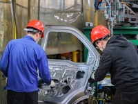 Workers work on the production line at the production workshop of Qingdao Wushun Auto Mold Parts Co., LTD., in West Coast New Area, Qingdao,...