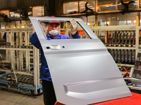 Workers work on the production line at the production workshop of Qingdao Wushun Auto Mold Parts Co., LTD., in West Coast New Area, Qingdao,...