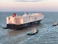 The car carrier ''BYD Changzhou'' departs with the assistance of a tugboat at CIMC Raffles' Shandong Longkou construction base in Yantai, Ch...