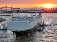 The car carrier ''BYD Changzhou'' departs with the assistance of a tugboat at CIMC Raffles' Shandong Longkou construction base in Yantai, Ch...