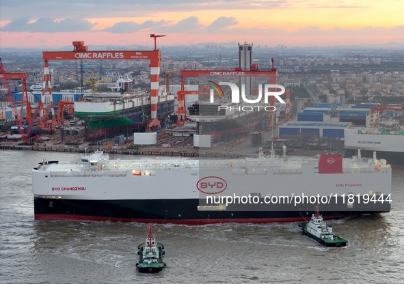 The car carrier ''BYD Changzhou'' departs with the assistance of a tugboat at CIMC Raffles' Shandong Longkou construction base in Yantai, Ch...