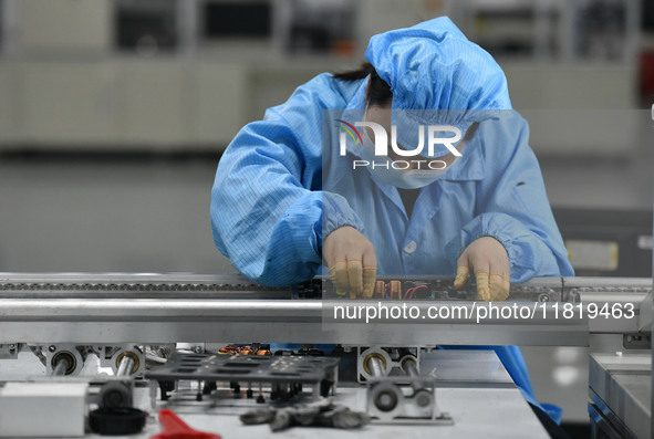 An employee works on a circuit board production line at the workshop of Anhui Shixin Electronic Technology Co LTD in Fuyang, China, on Novem...