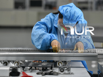 An employee works on a circuit board production line at the workshop of Anhui Shixin Electronic Technology Co LTD in Fuyang, China, on Novem...