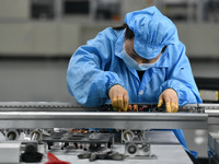 An employee works on a circuit board production line at the workshop of Anhui Shixin Electronic Technology Co LTD in Fuyang, China, on Novem...