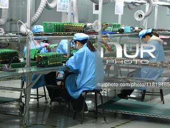 Employees work on a circuit board production line at the workshop of Anhui Shixin Electronic Technology Co LTD in Fuyang, China, on November...