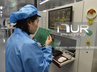 An employee works on a circuit board production line at the workshop of Anhui Shixin Electronic Technology Co LTD in Fuyang, China, on Novem...