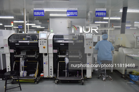 An employee works on a circuit board production line at the workshop of Anhui Shixin Electronic Technology Co LTD in Fuyang, China, on Novem...