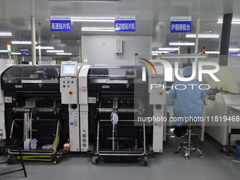 An employee works on a circuit board production line at the workshop of Anhui Shixin Electronic Technology Co LTD in Fuyang, China, on Novem...