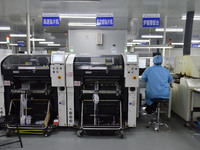 An employee works on a circuit board production line at the workshop of Anhui Shixin Electronic Technology Co LTD in Fuyang, China, on Novem...