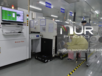 An employee works on a circuit board production line at the workshop of Anhui Shixin Electronic Technology Co LTD in Fuyang, China, on Novem...