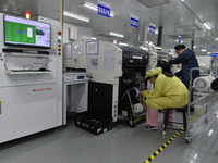 An employee works on a circuit board production line at the workshop of Anhui Shixin Electronic Technology Co LTD in Fuyang, China, on Novem...