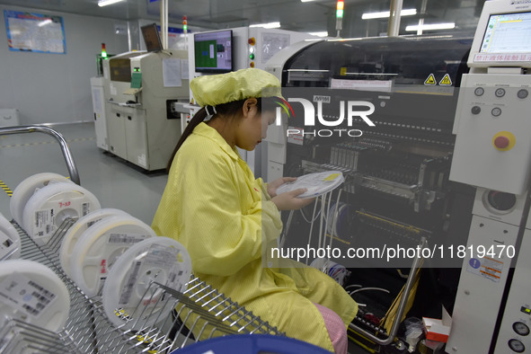 An employee works on a circuit board production line at the workshop of Anhui Shixin Electronic Technology Co LTD in Fuyang, China, on Novem...