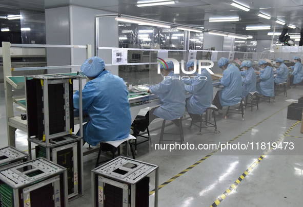 Employees work on a circuit board production line at the workshop of Anhui Shixin Electronic Technology Co LTD in Fuyang, China, on November...