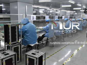 Employees work on a circuit board production line at the workshop of Anhui Shixin Electronic Technology Co LTD in Fuyang, China, on November...