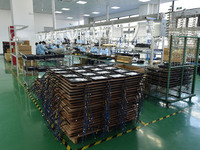 Employees work on a production line of wireless power supply products at the workshop of Zhonghui Chuangzhi (Fuyang) Technology Co., LTD in...