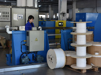 Employees work on a wire and cable production line at Anhui Aipu Huaton Electronic Technology Co LTD in Fuyang, China, on November 29, 2024....