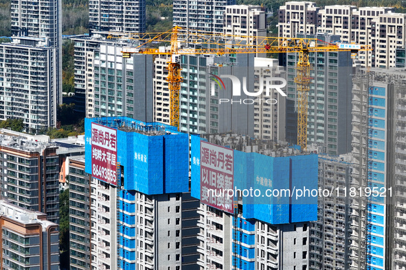 A large ''trade-in'' advertisement hangs on the outside of a commercial housing building under construction in Nanjing, China, on November 2...