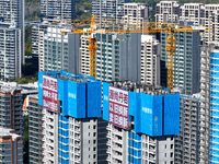 A large ''trade-in'' advertisement hangs on the outside of a commercial housing building under construction in Nanjing, China, on November 2...