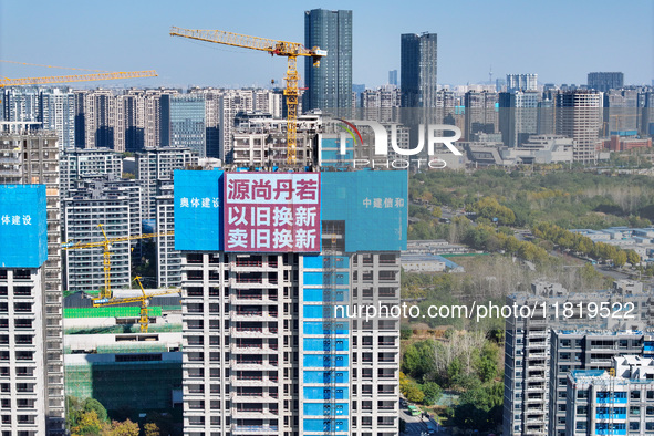 A large ''trade-in'' advertisement hangs on the outside of a commercial housing building under construction in Nanjing, China, on November 2...