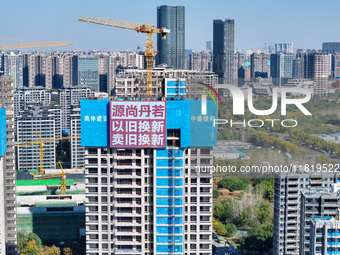 A large ''trade-in'' advertisement hangs on the outside of a commercial housing building under construction in Nanjing, China, on November 2...