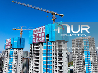 A large ''trade-in'' advertisement hangs on the outside of a commercial housing building under construction in Nanjing, China, on November 2...